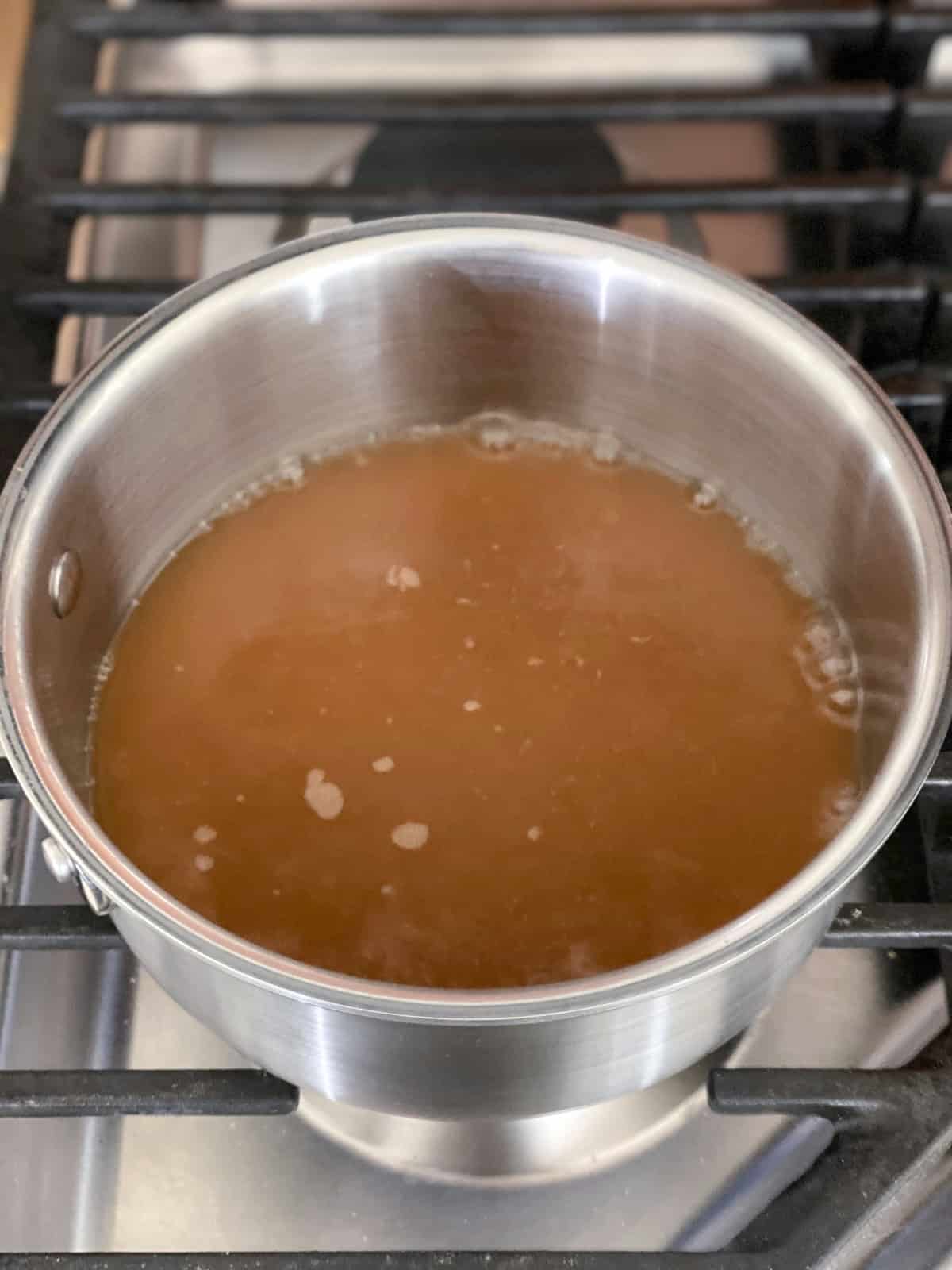apple cider reducing on stove