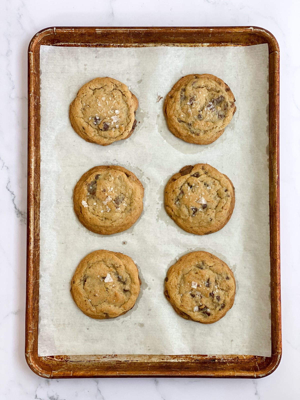 Baked chocolate chunk cookies on a baking sheet.