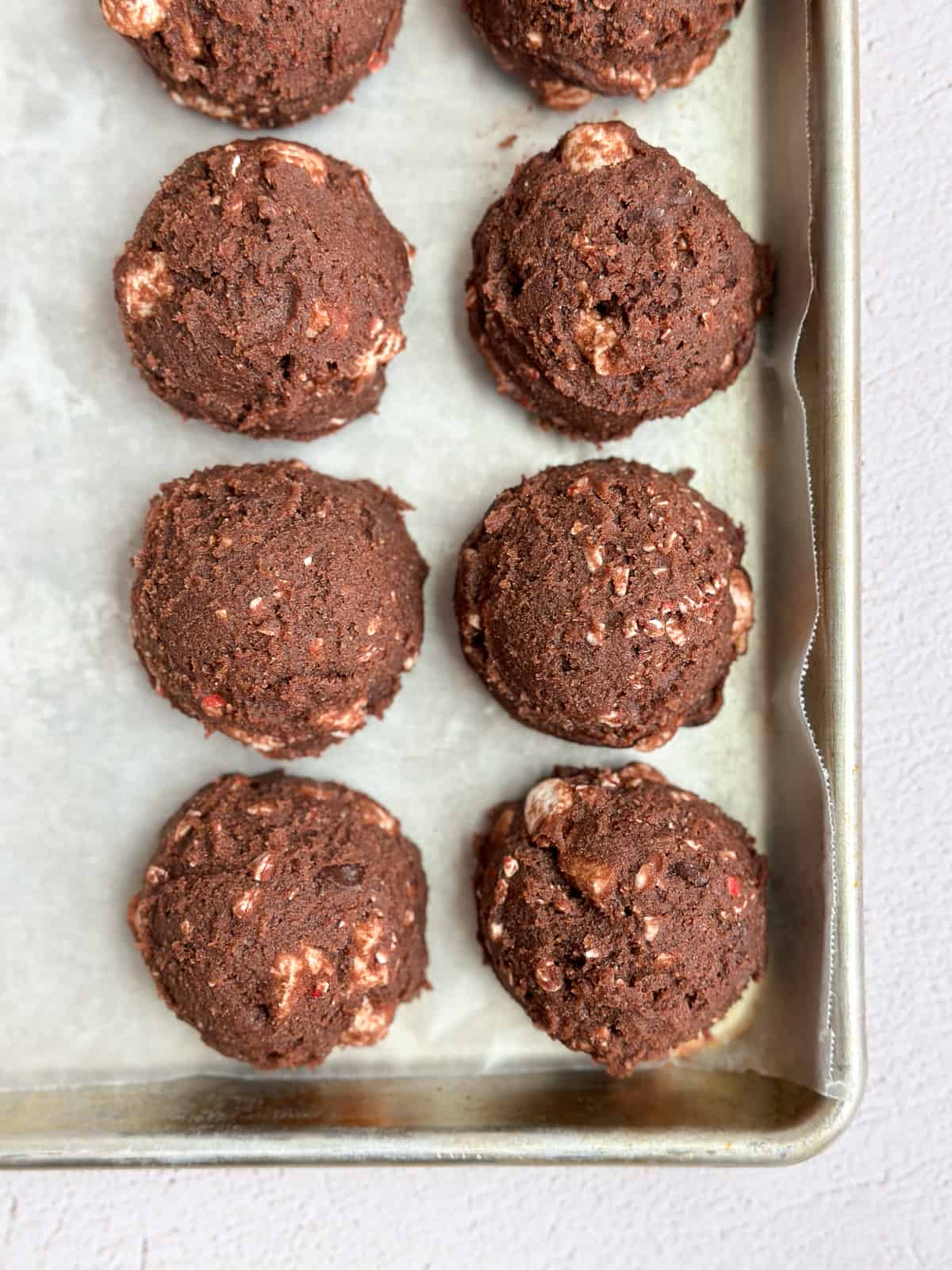 peppermint hot chocolate cookie dough balls all lined up.