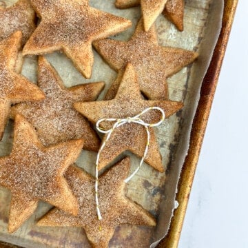a bunch of cinnamon shortbread cookies stacked with a bow on top.