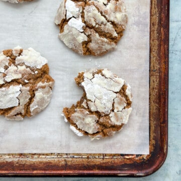 molasses crinkle cookies with a bite missing from one.