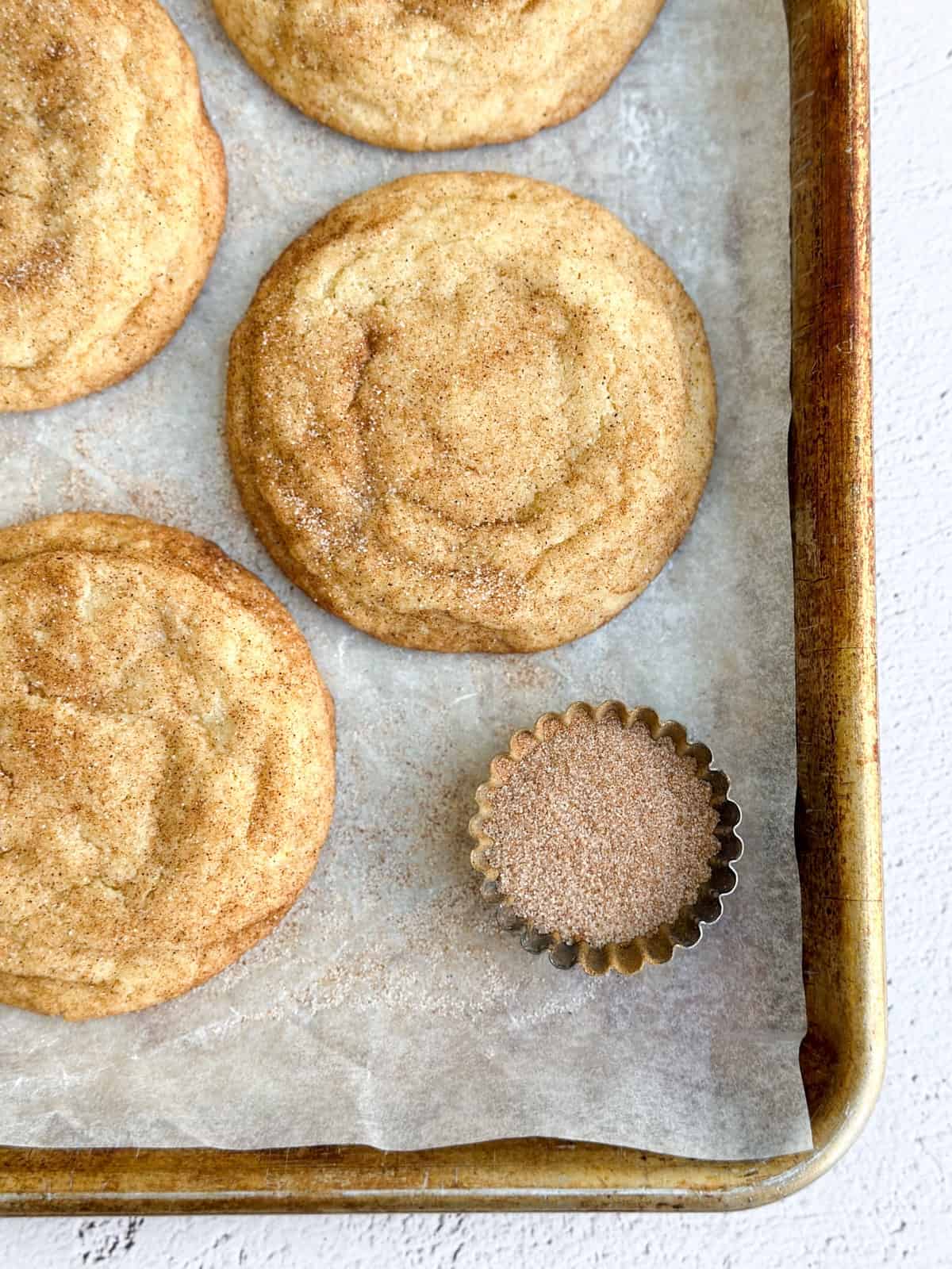 2 of the small batch snickerdoodles with cinnamon and sugar to the side.