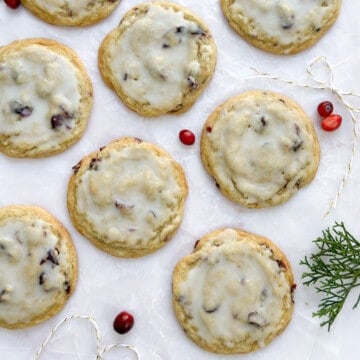 lemon cranberry cookies with extras cranberries around.