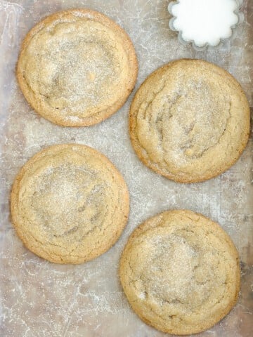 4 small batch sugar cookies on a baking sheet.