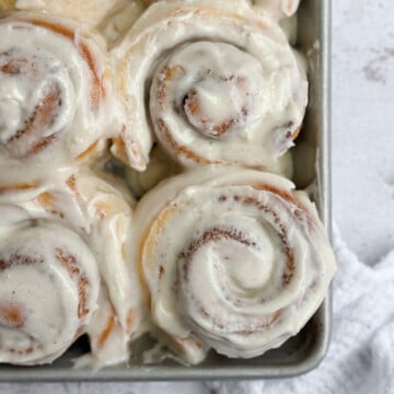 a close up of these small batch cinnamon rolls in the pan.
