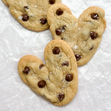 Heart shaped chocolate chip cookies stacked on top of each other.
