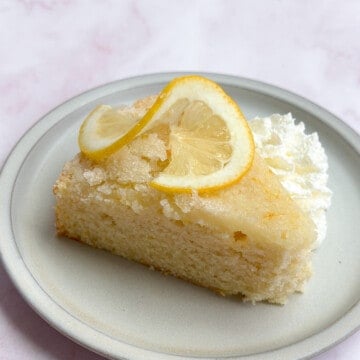 a single slice of this easy lemon snack cake with a slice of lemon on top.