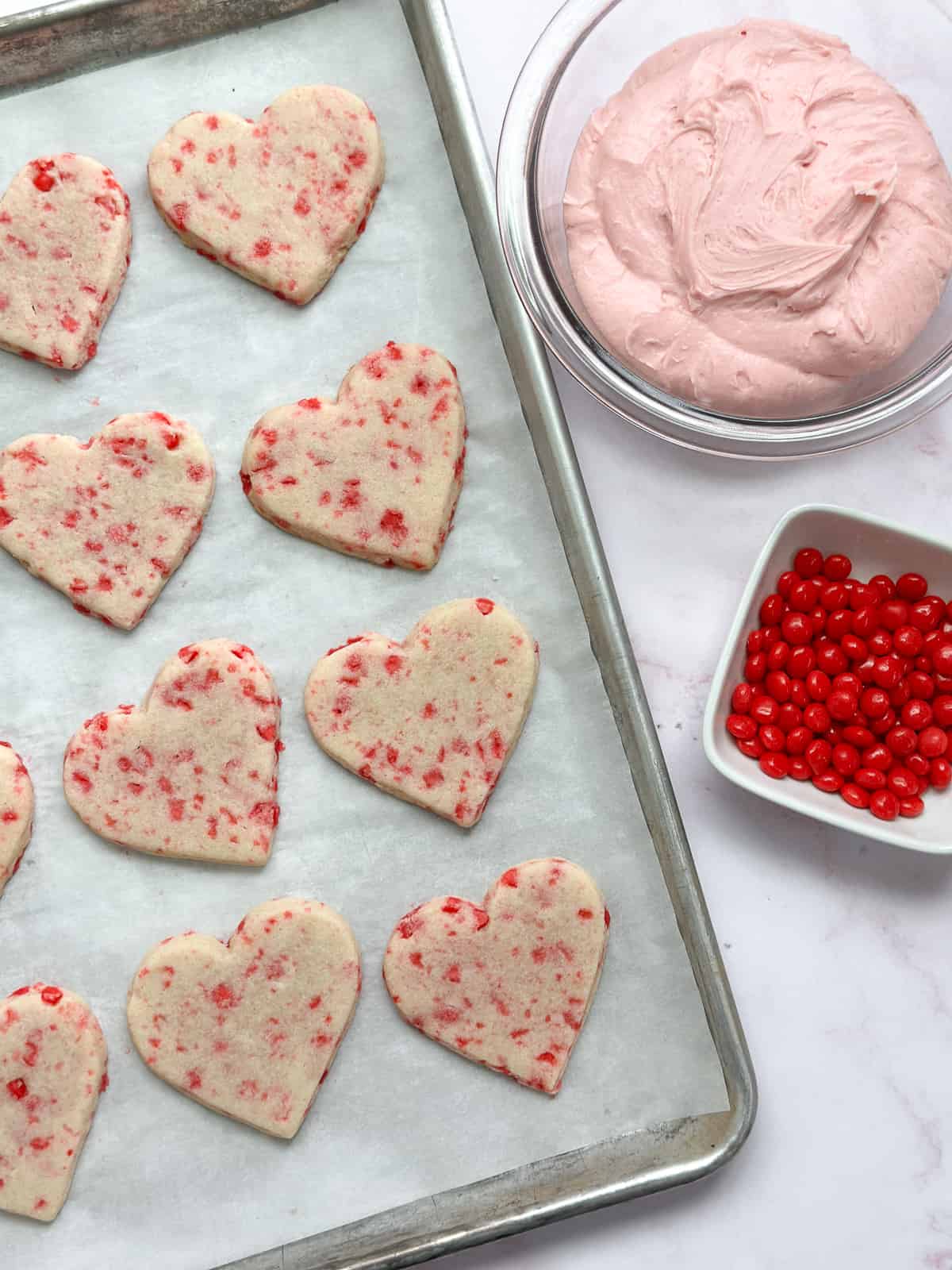the cookies, buttercream and red hots all sitting side by side before assembling.