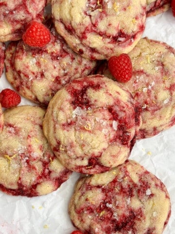 lemon raspberry cookies all stacked on top of each other.