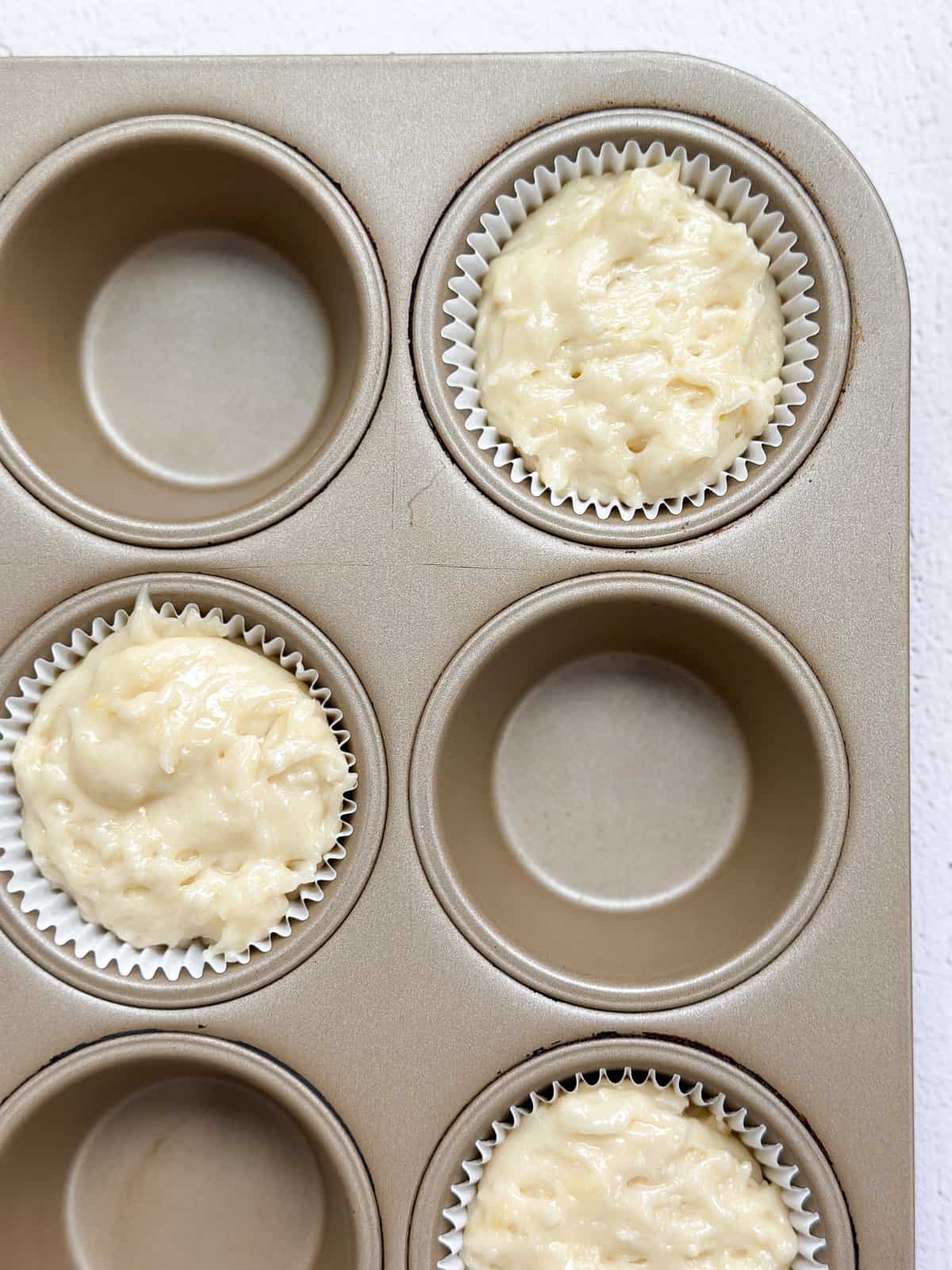 muffin batter in muffin cups.