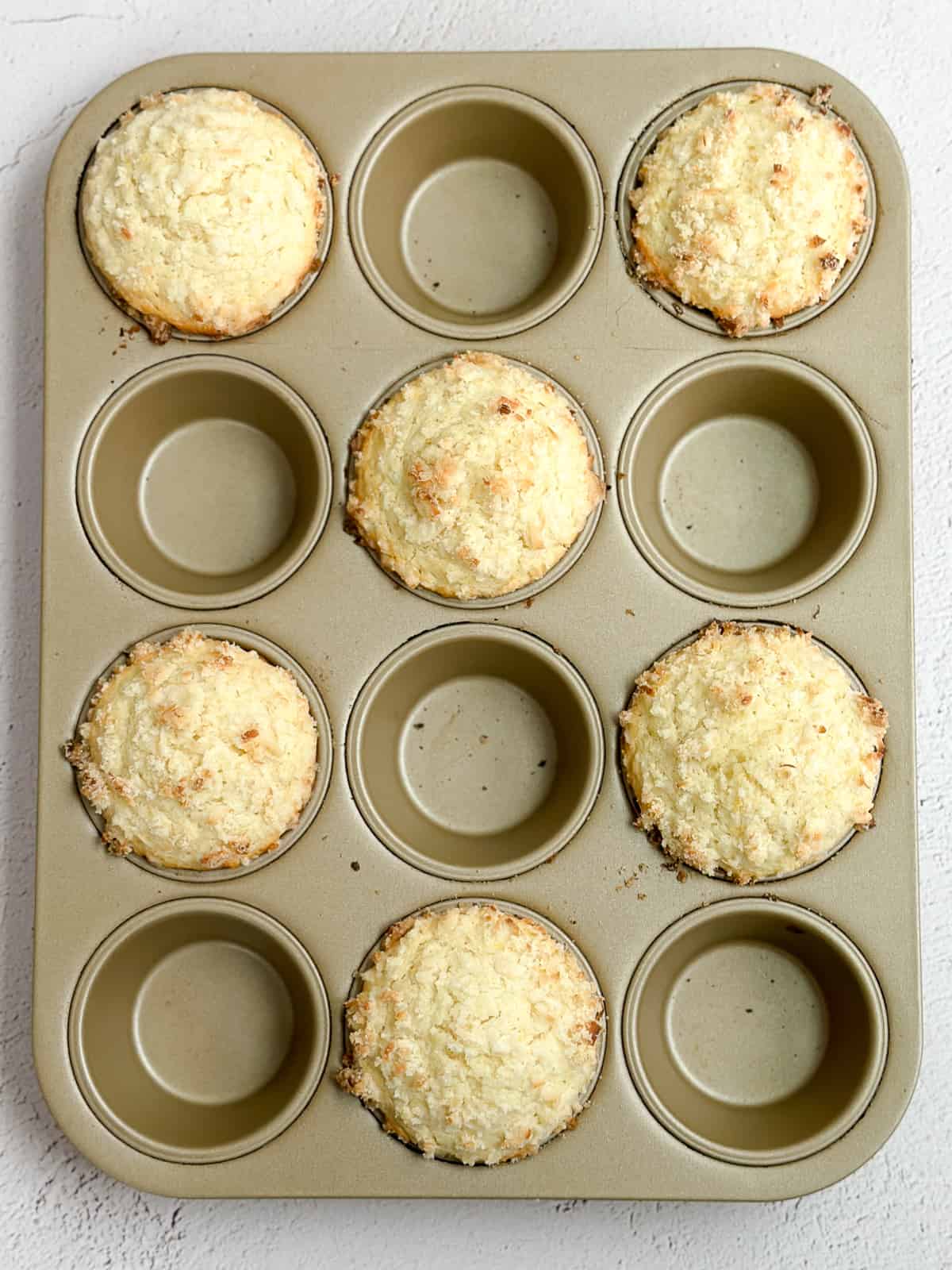 muffins staggered in a muffin tin and freshly baked.