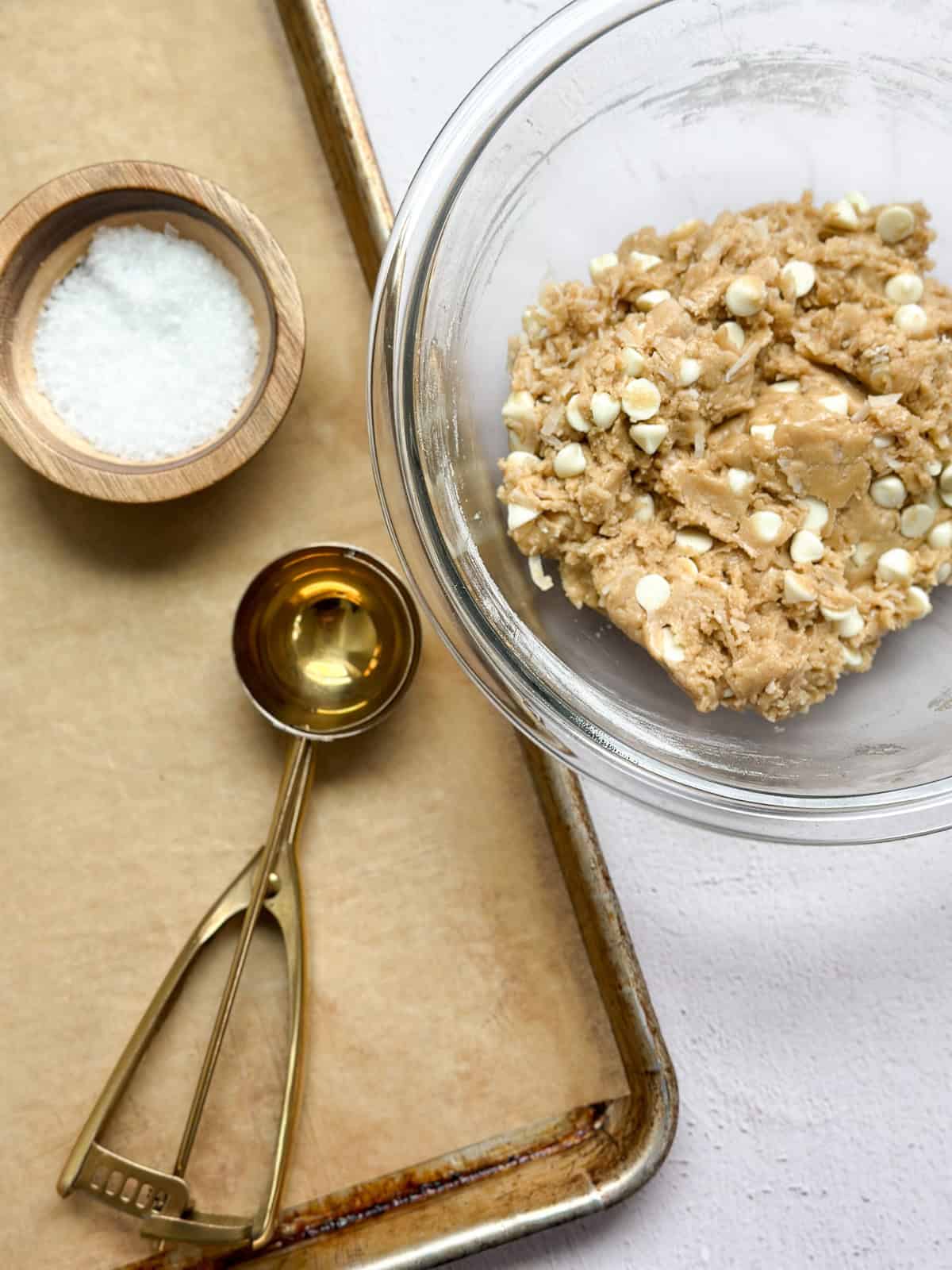 a cookie sheet, the cookie dough and some flaked sea salt.