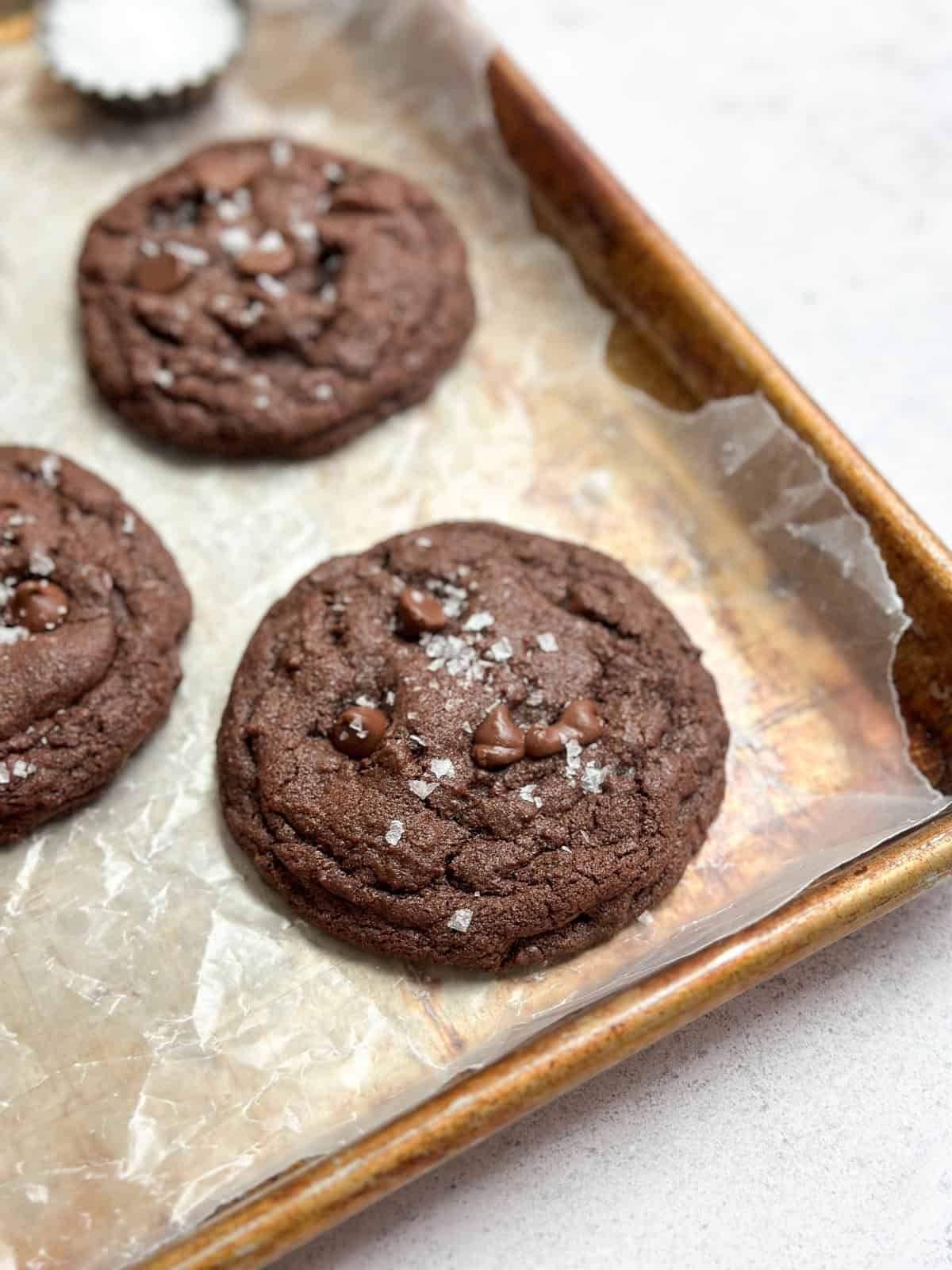 a picture of the small batch chocolate cookies on a baking sheet showing the salty top.