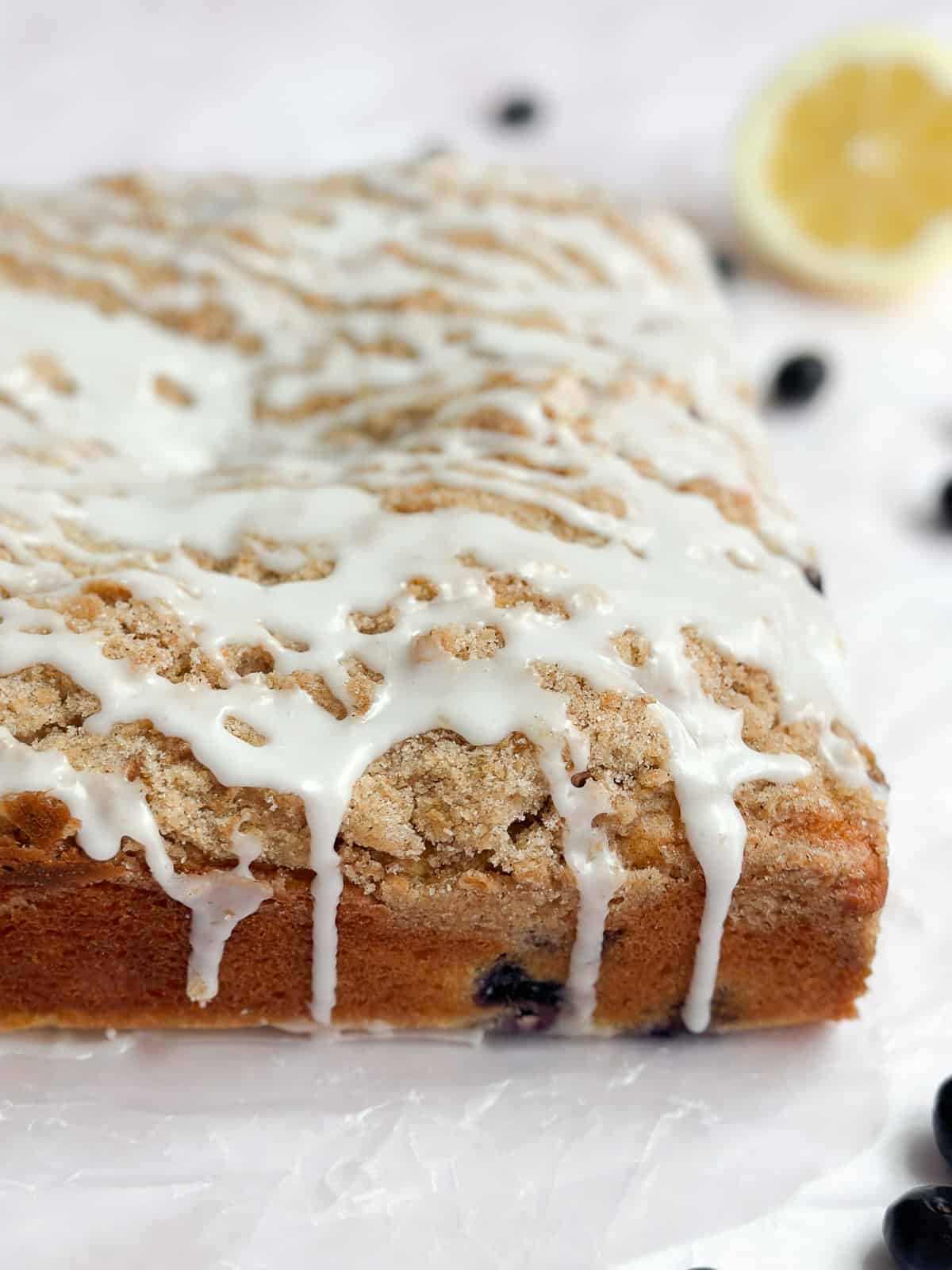 a side view of the lemon glaze drizzling down the cake.