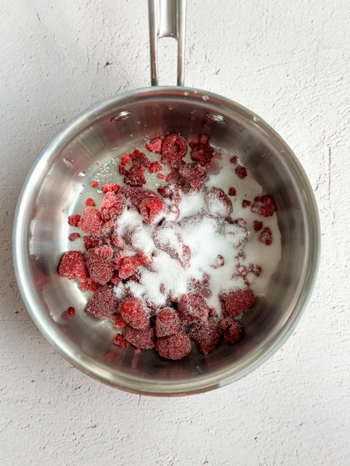 all the ingredients to make raspberry sauce.