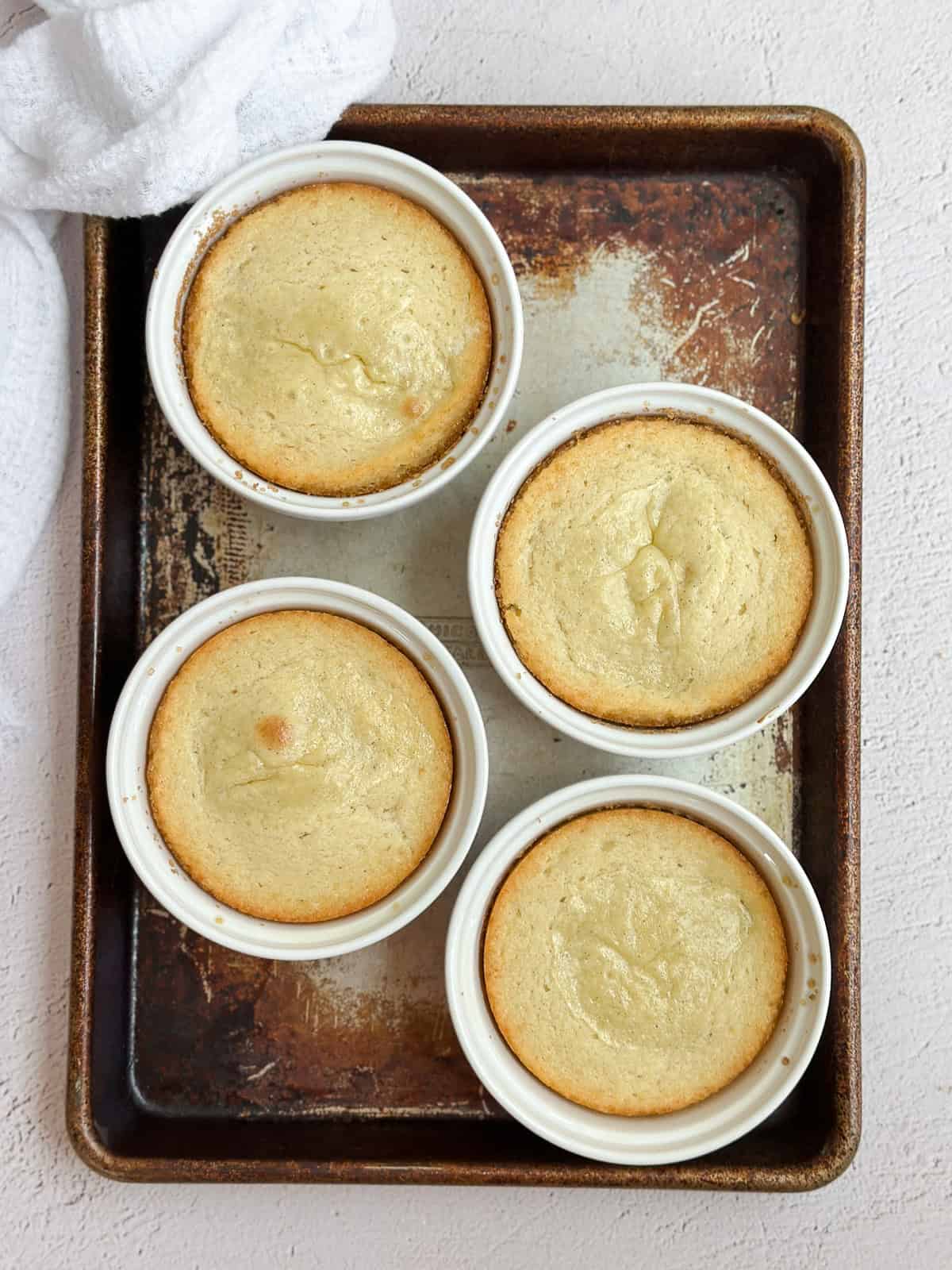 all four butter cakes on a cookie sheet after baking.