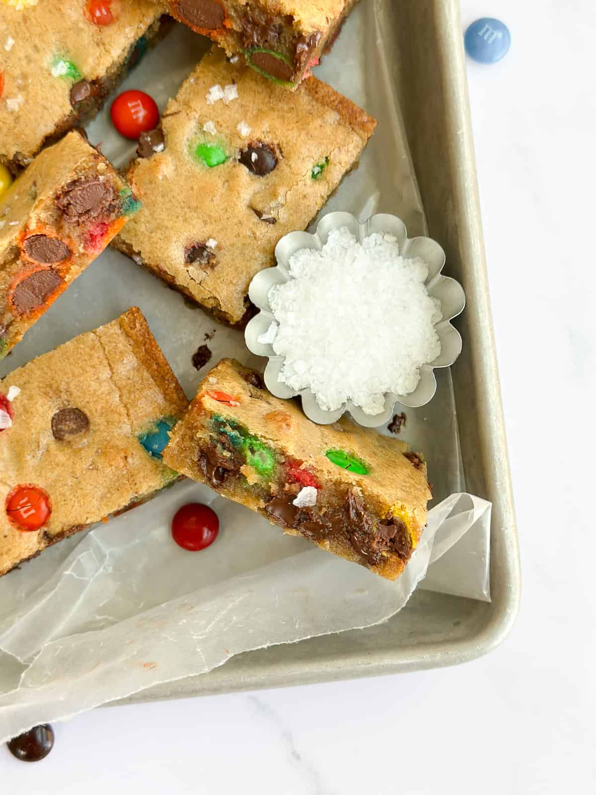 a browned butter m&m blondie turned up to see the inside texture.