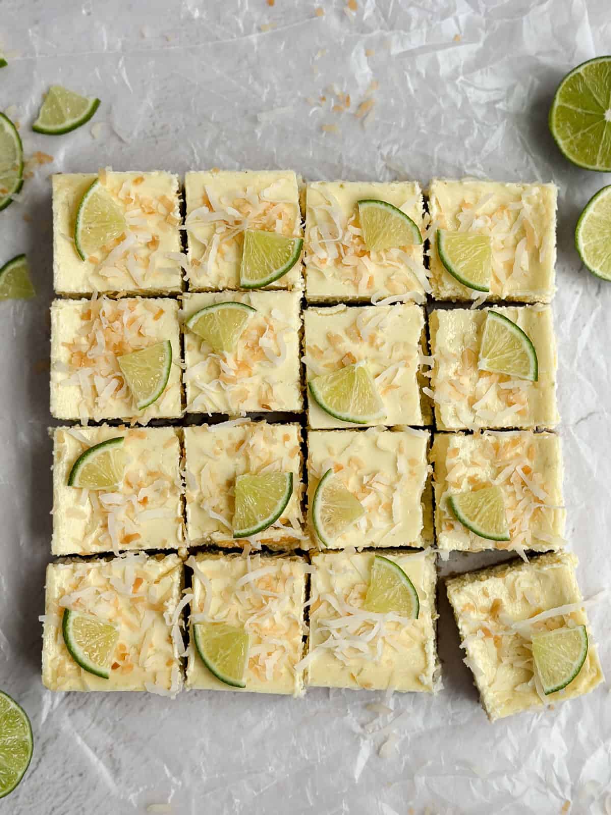 cheesecake bars topped with toasted coconut and cut into squares.