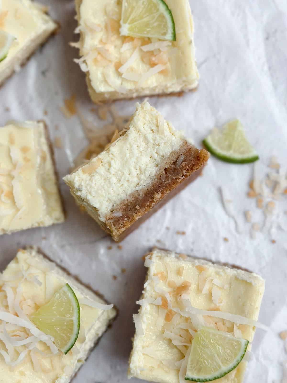 a piece of cheesecake turned on its side to see the texture of the crust and cheesecake.