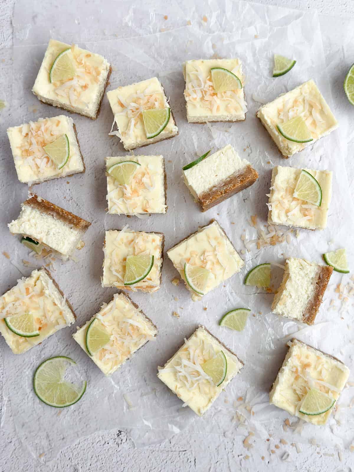 all the coconut lime cheesecake bars cut into squares and scattered.