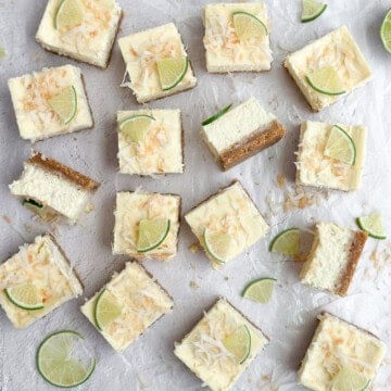 all the coconut lime cheesecake bars cut into squares and scattered.
