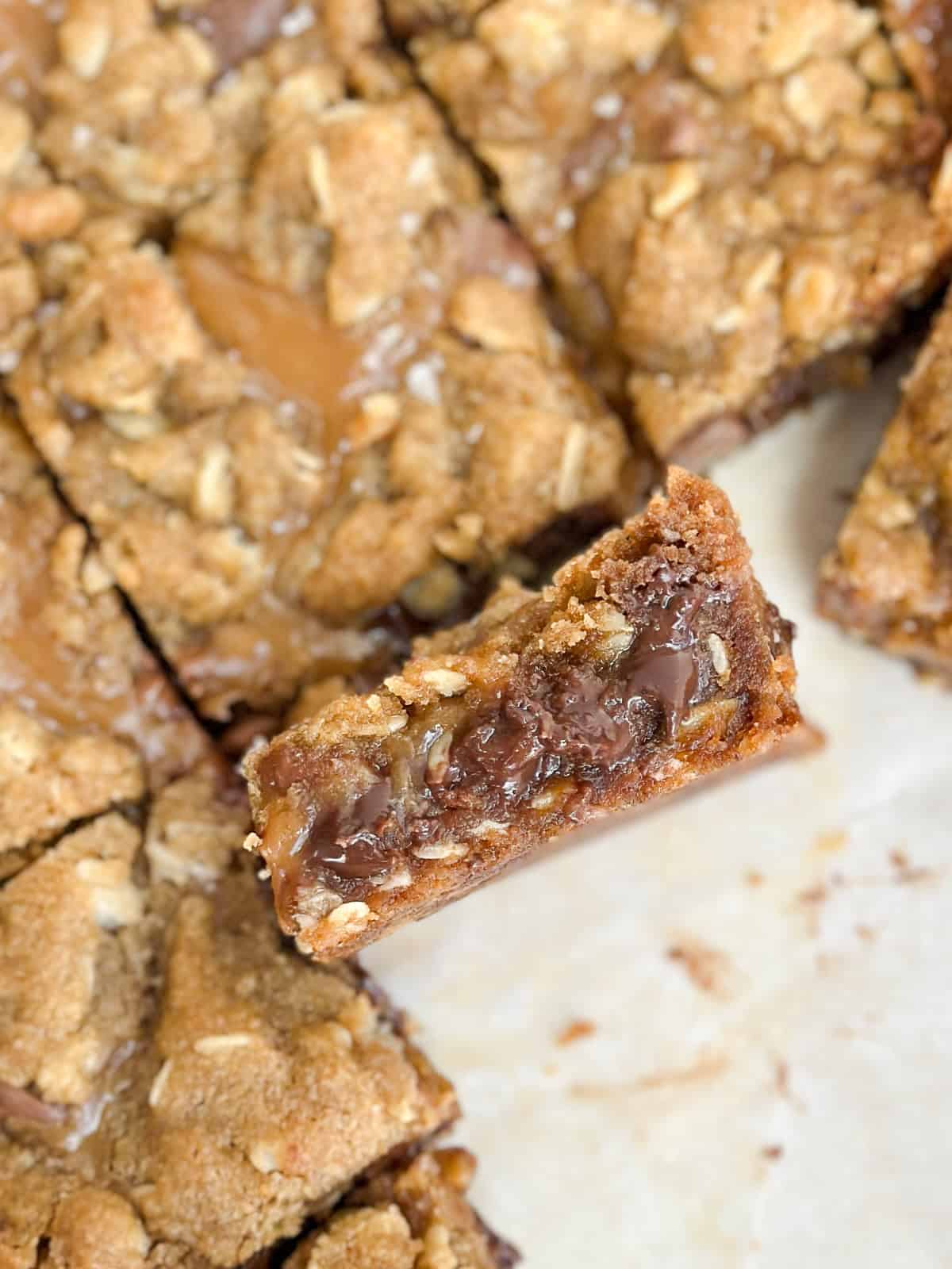 a square of the oatmeal carmelita toffee bar turned up so you can see the inside texture.
