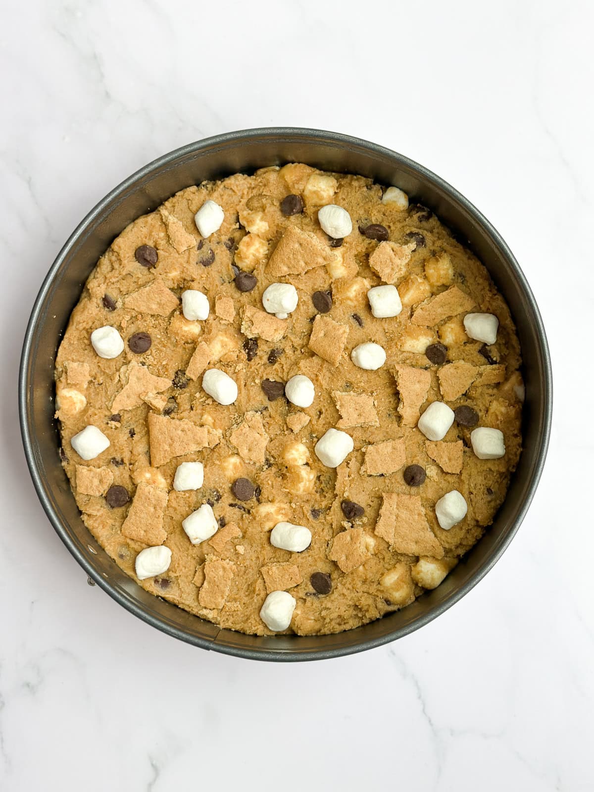 the cookie dough in the pan, topped with marshmallows and chocolate chips before baking.