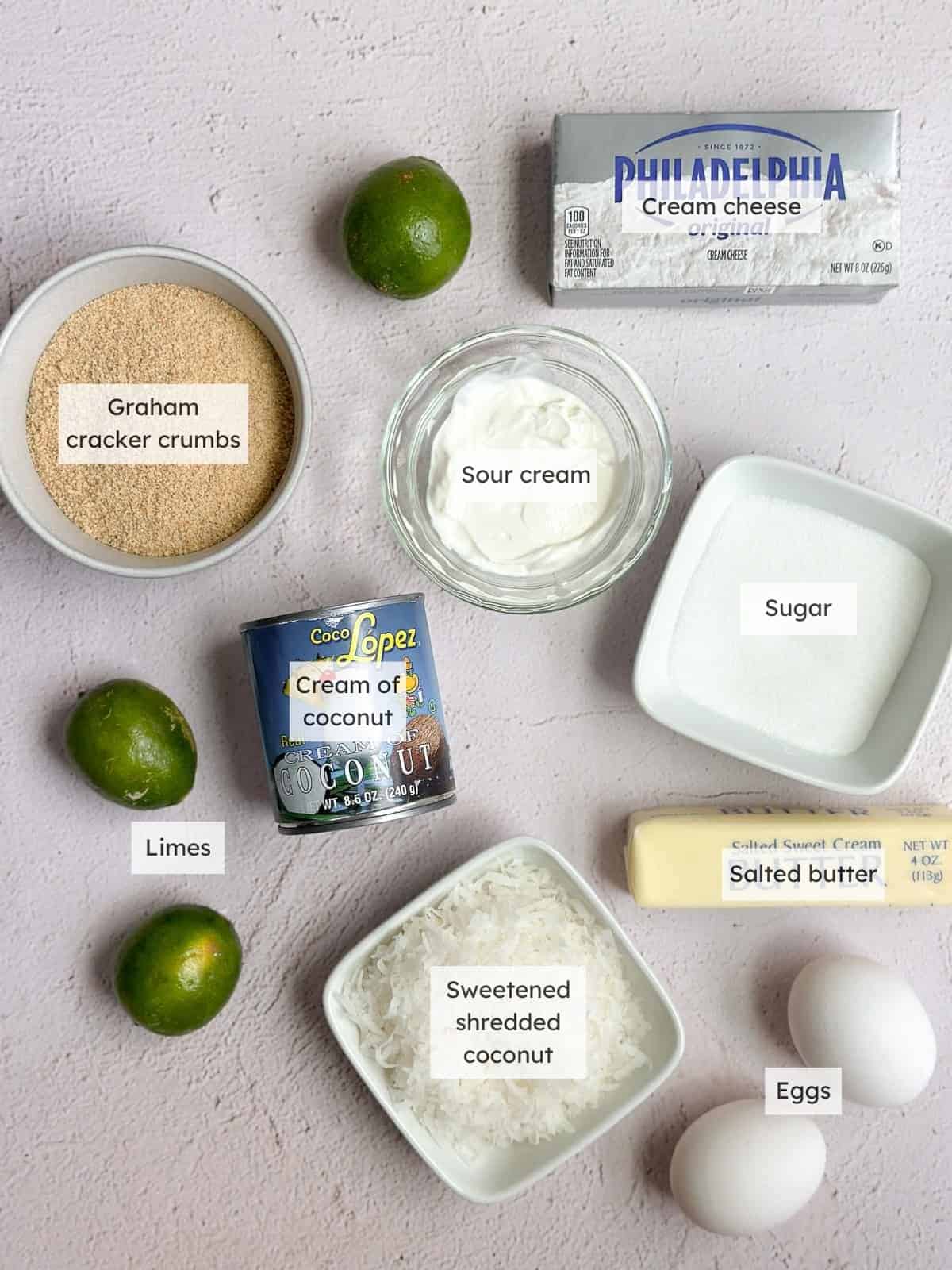 All of the ingredients needed to make coconut lime cheesecake.