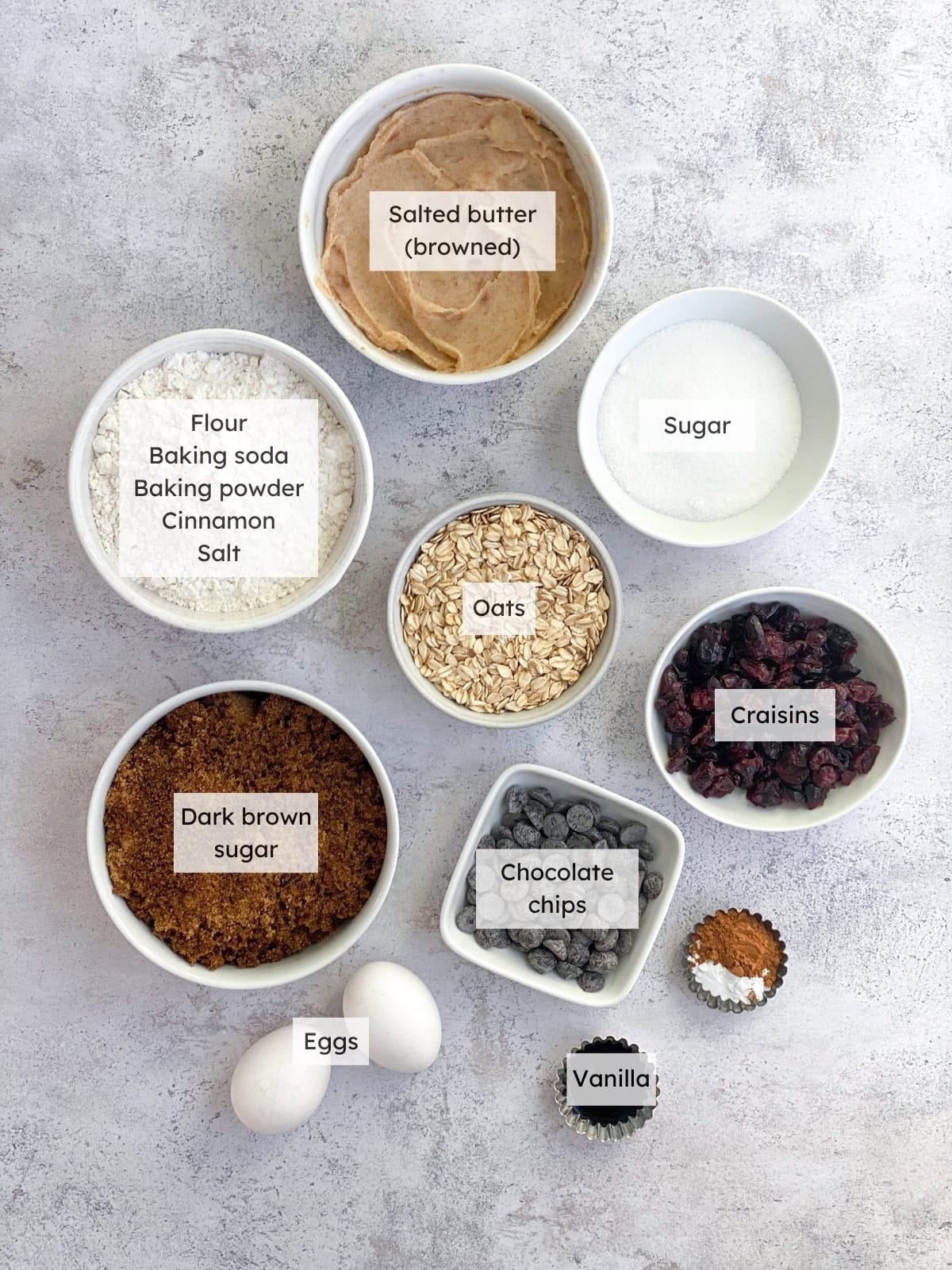 All of the ingredients needed to make oatmeal craisin cookies.