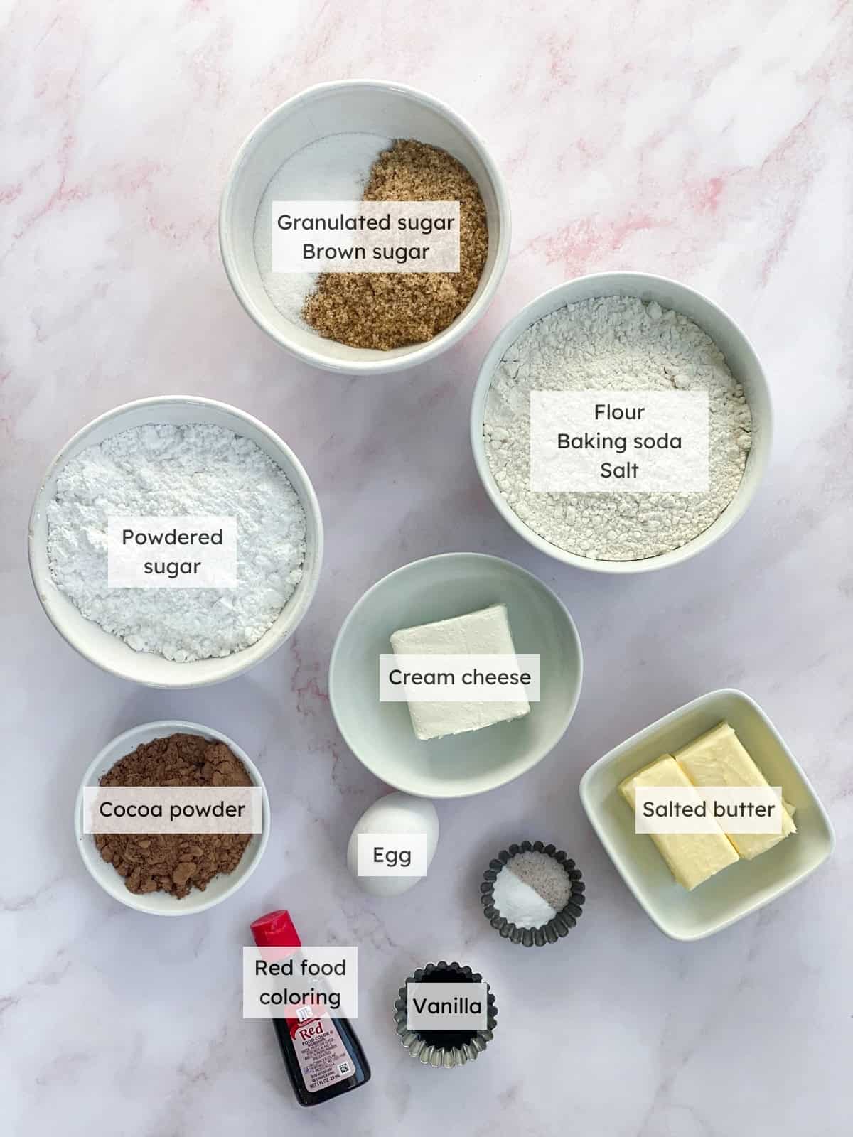 All of the ingredients needed to make red velvet oreo cookies.