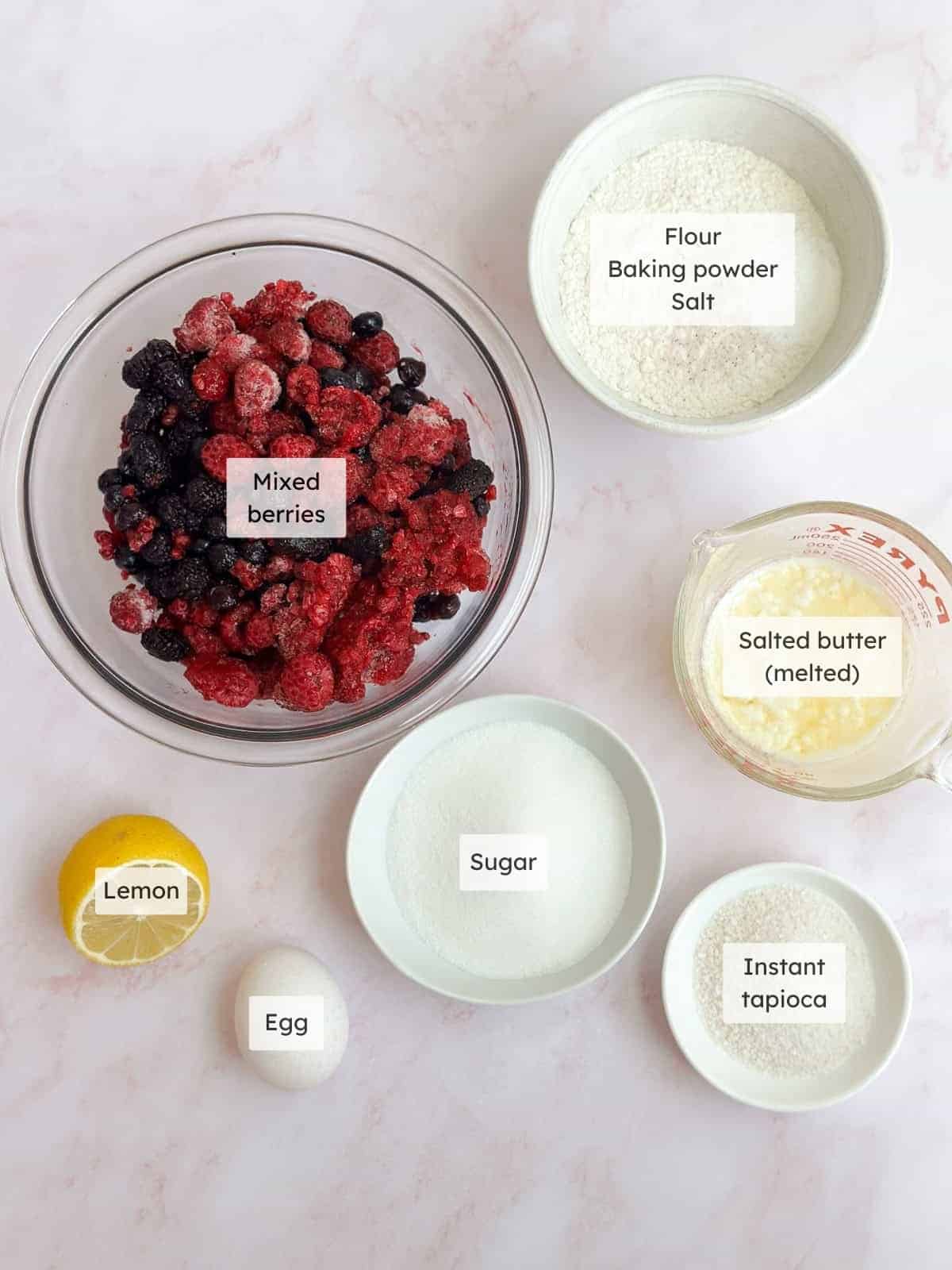 All of the ingredients needed to make mixed berry cobbler.