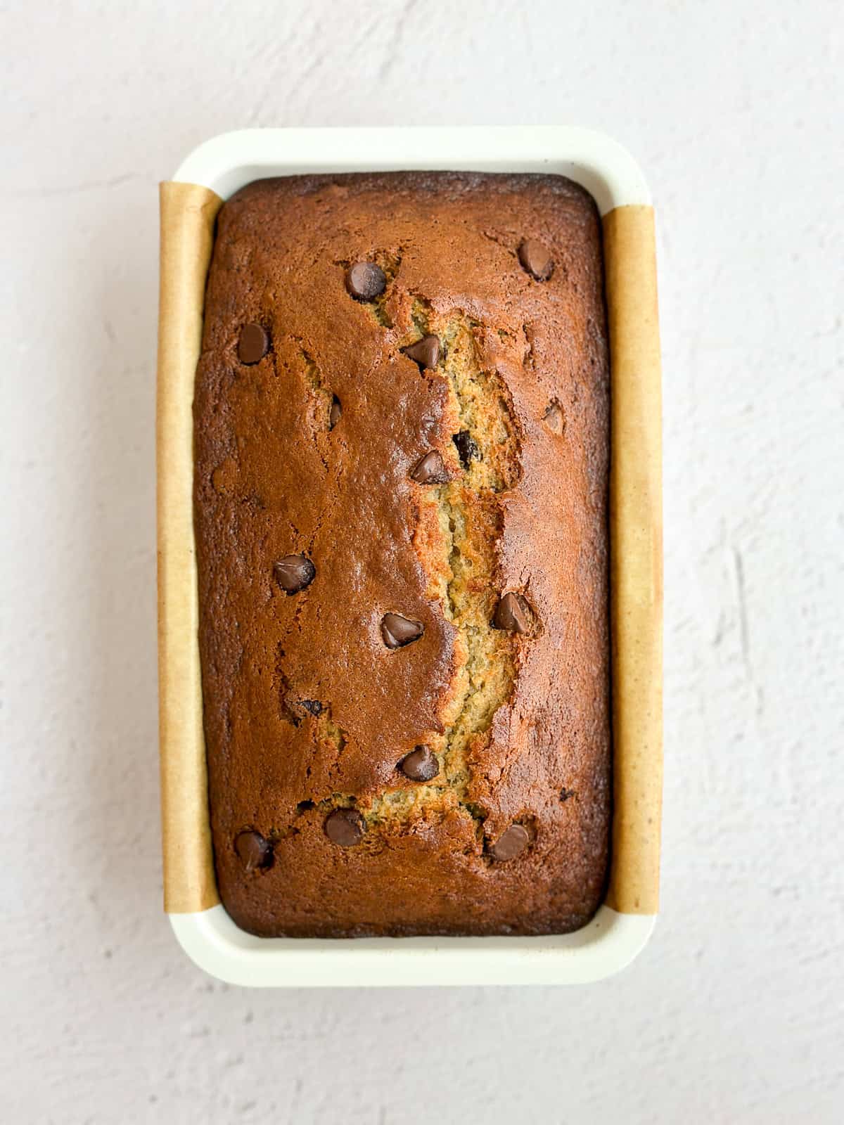 banana bread with chocolate chips in the pan after baking.