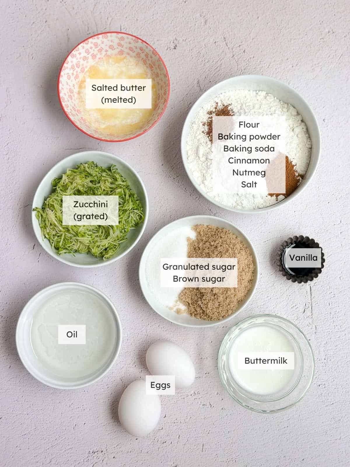 All of the ingredients needed to make cinnamon zucchini crumb muffins.