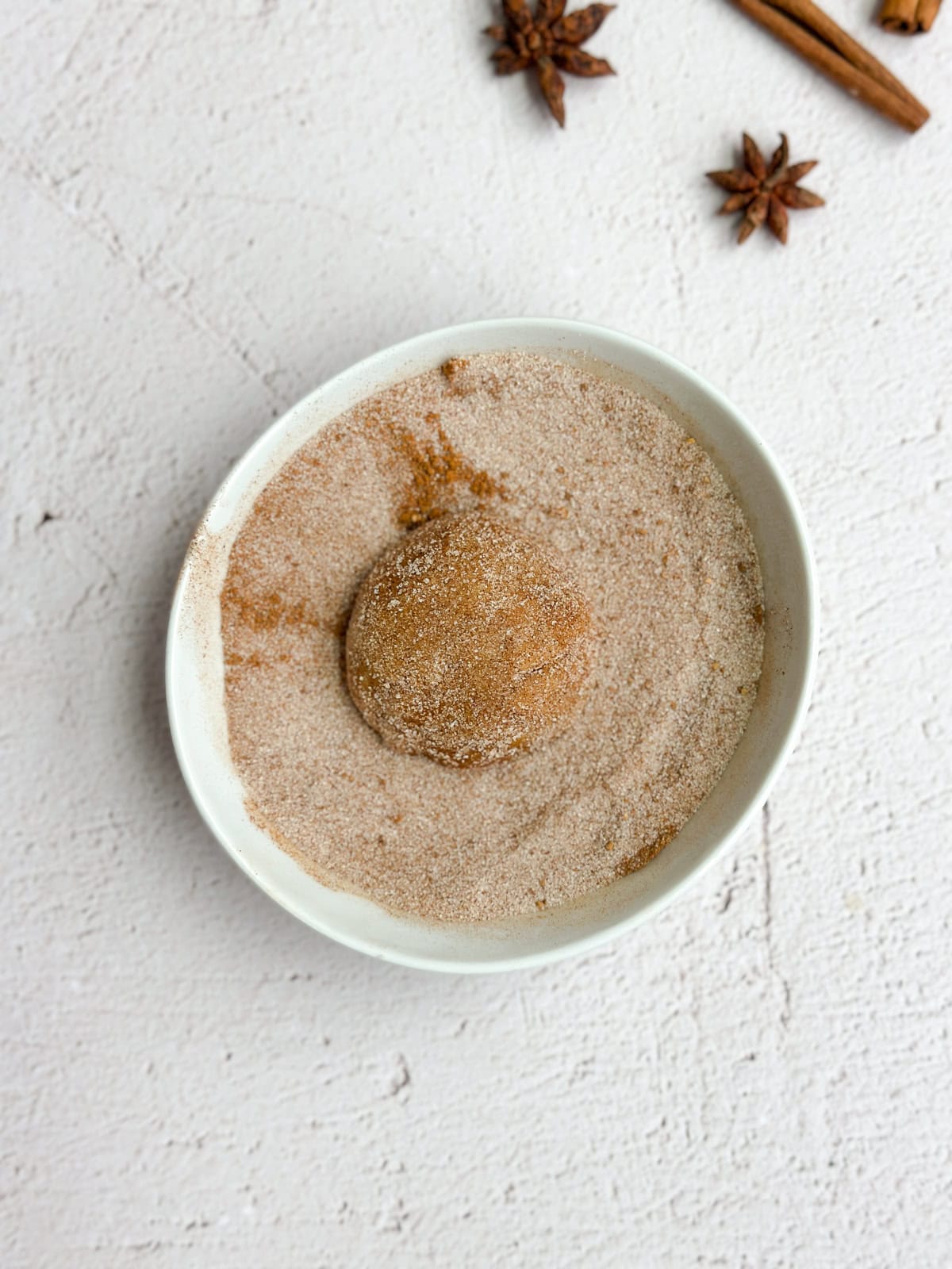 cookie ball being rolled in sugar.
