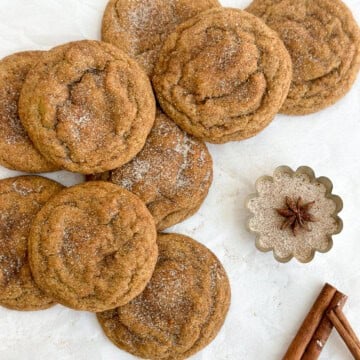 a group of browned butter pumpkin snickerdoodles stacked on top of each other.