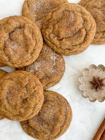a group of browned butter pumpkin snickerdoodles stacked on top of each other.