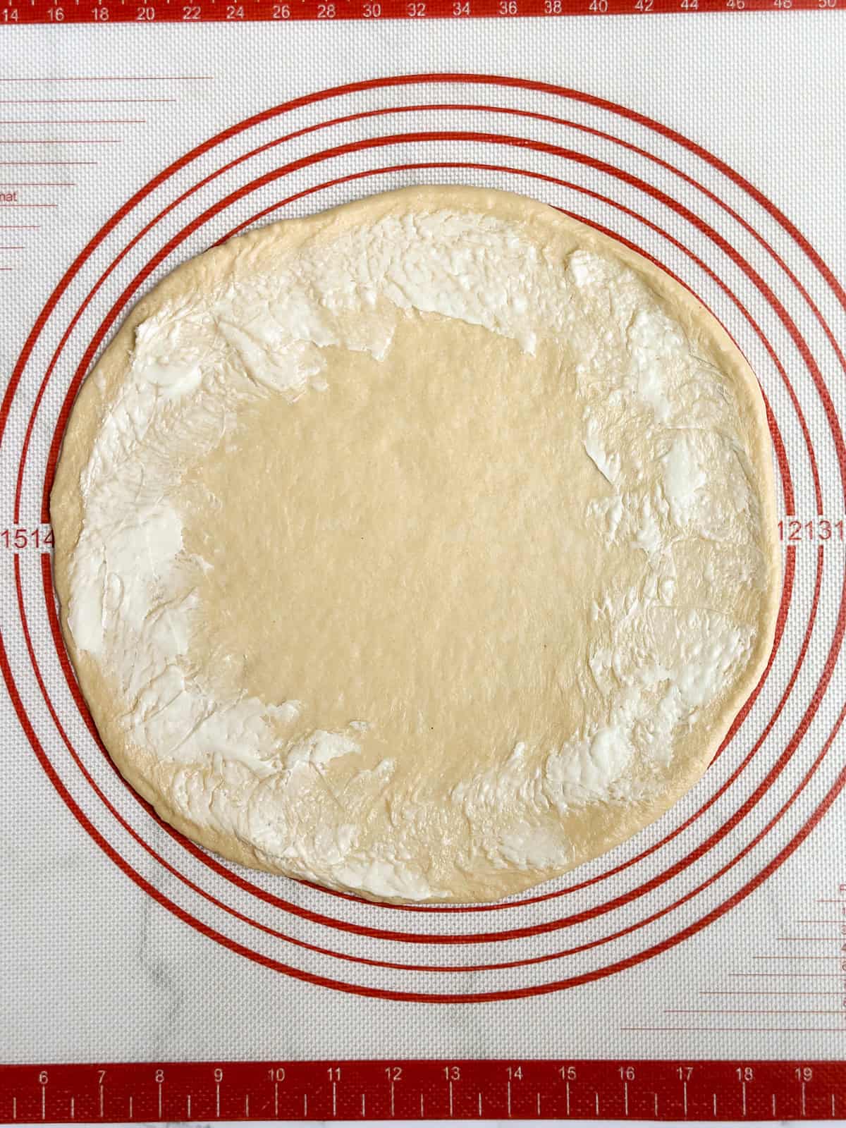 butter around the edge of the circle.