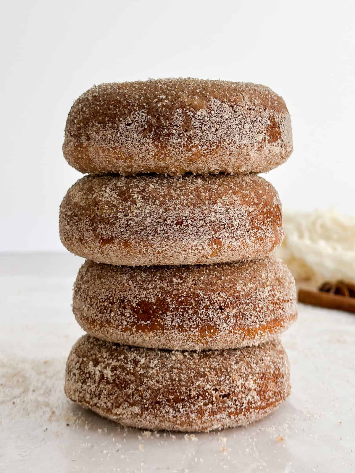a tall stack of baked apple cider donuts.