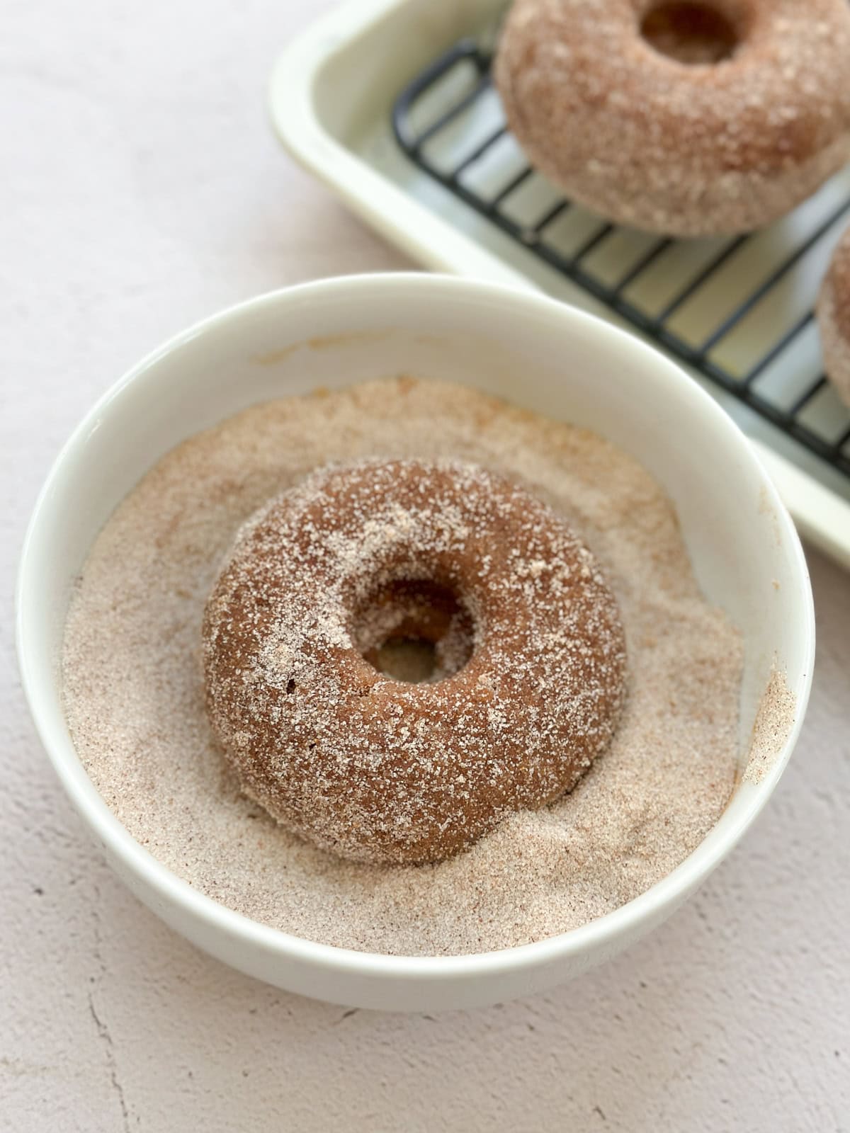 apple cider donuts in cinnamon sugar bowl.