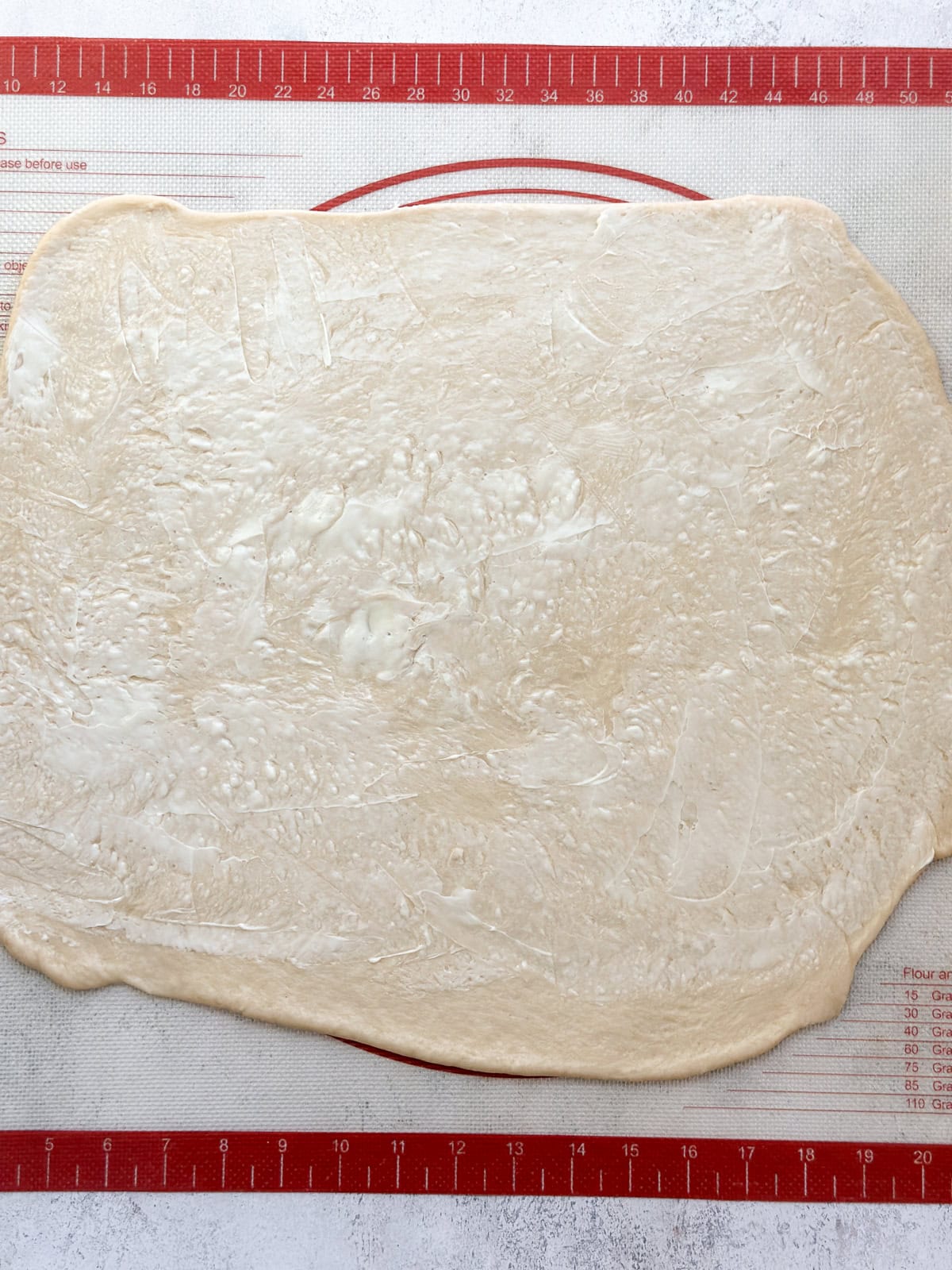 dough rolled into a rectangle and topped with butter.
