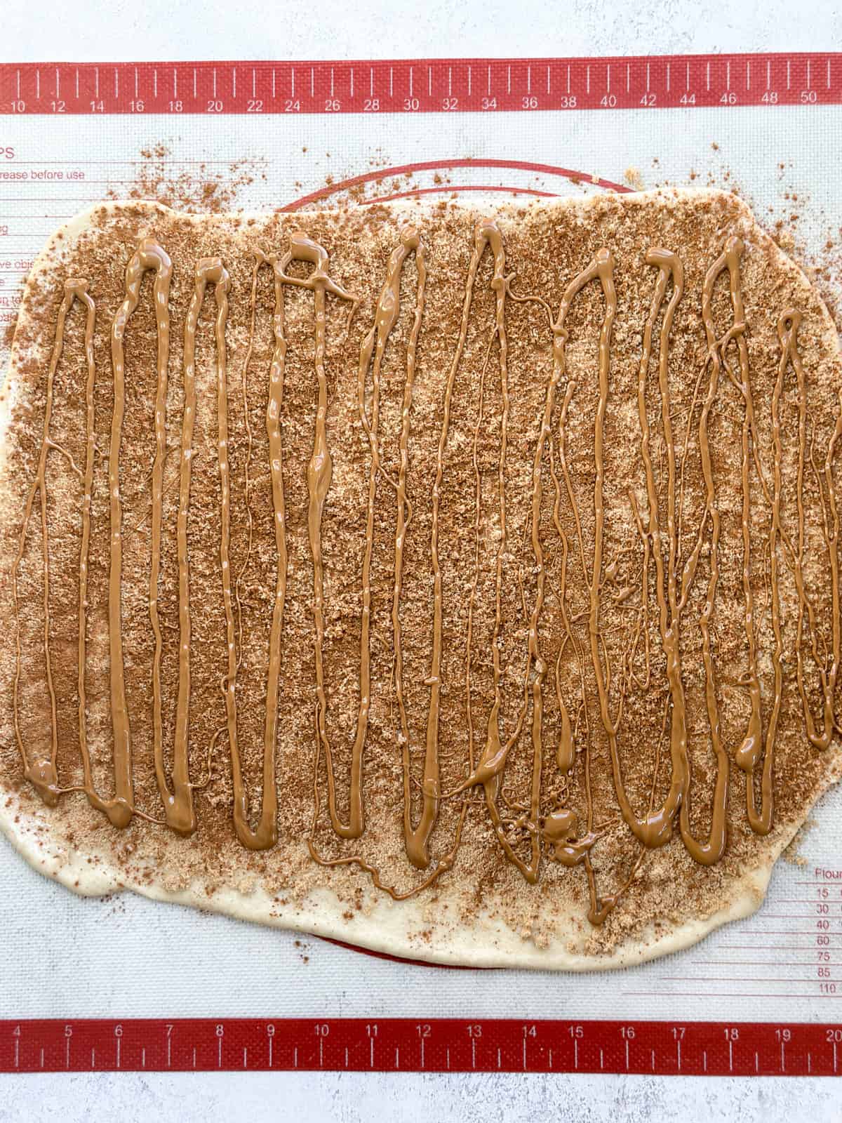 cinnamon rolls dough topped with cinnamon, sugar and biscoff spread.