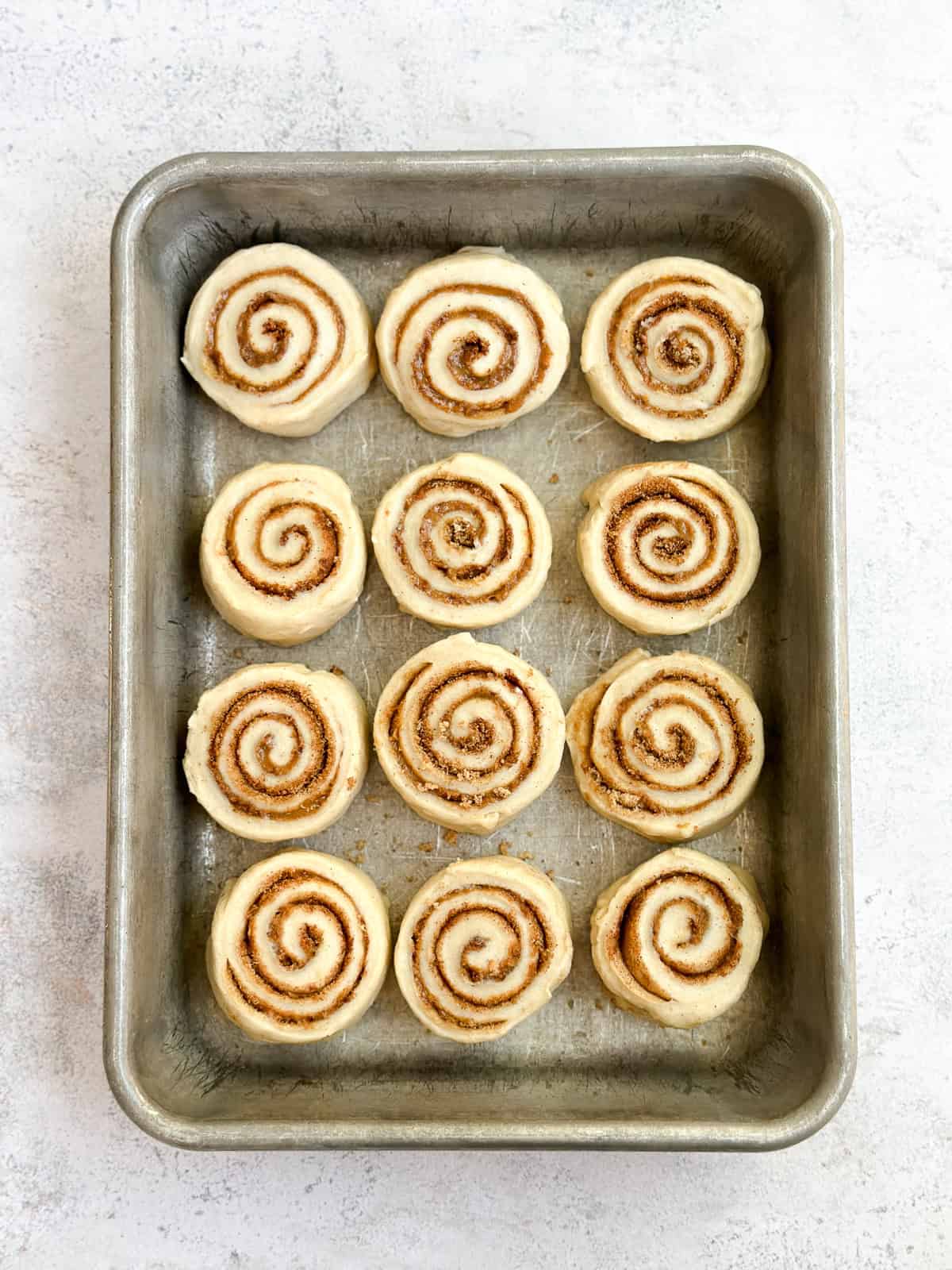 cinnamon rolls into the pan before starting to rise.