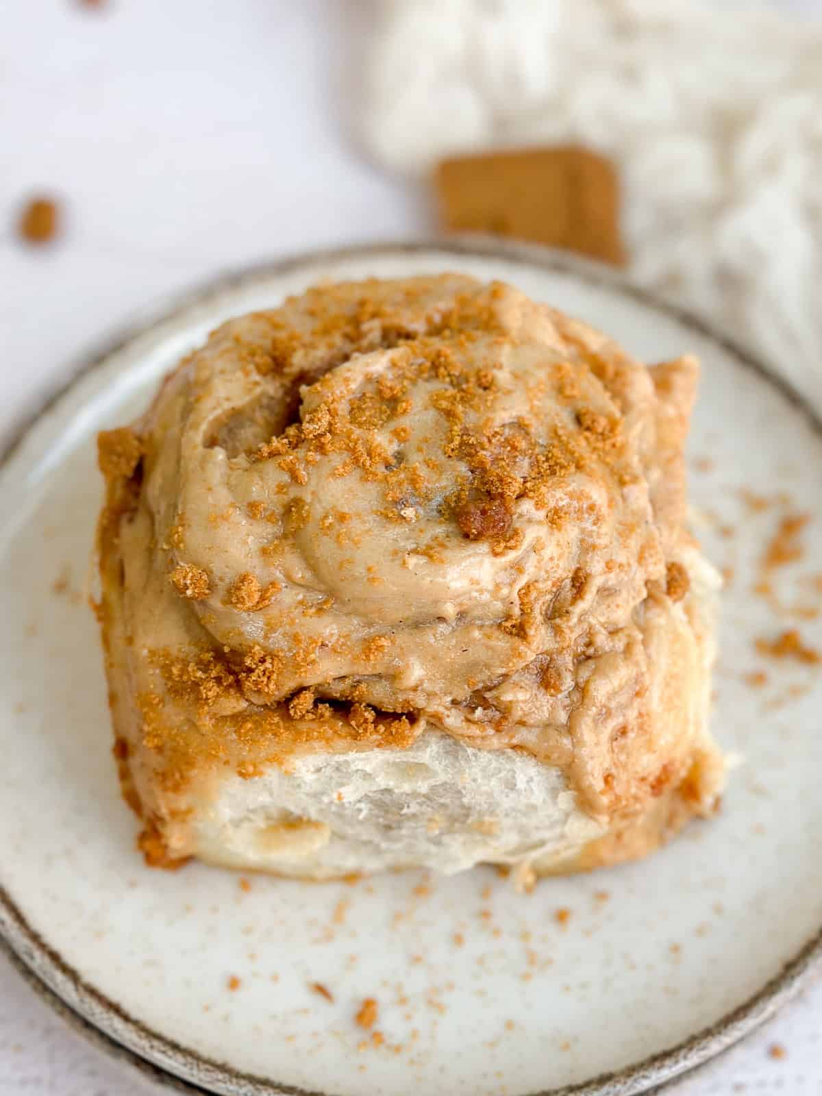 a close up of a biscoff cinnamon roll on a plate.