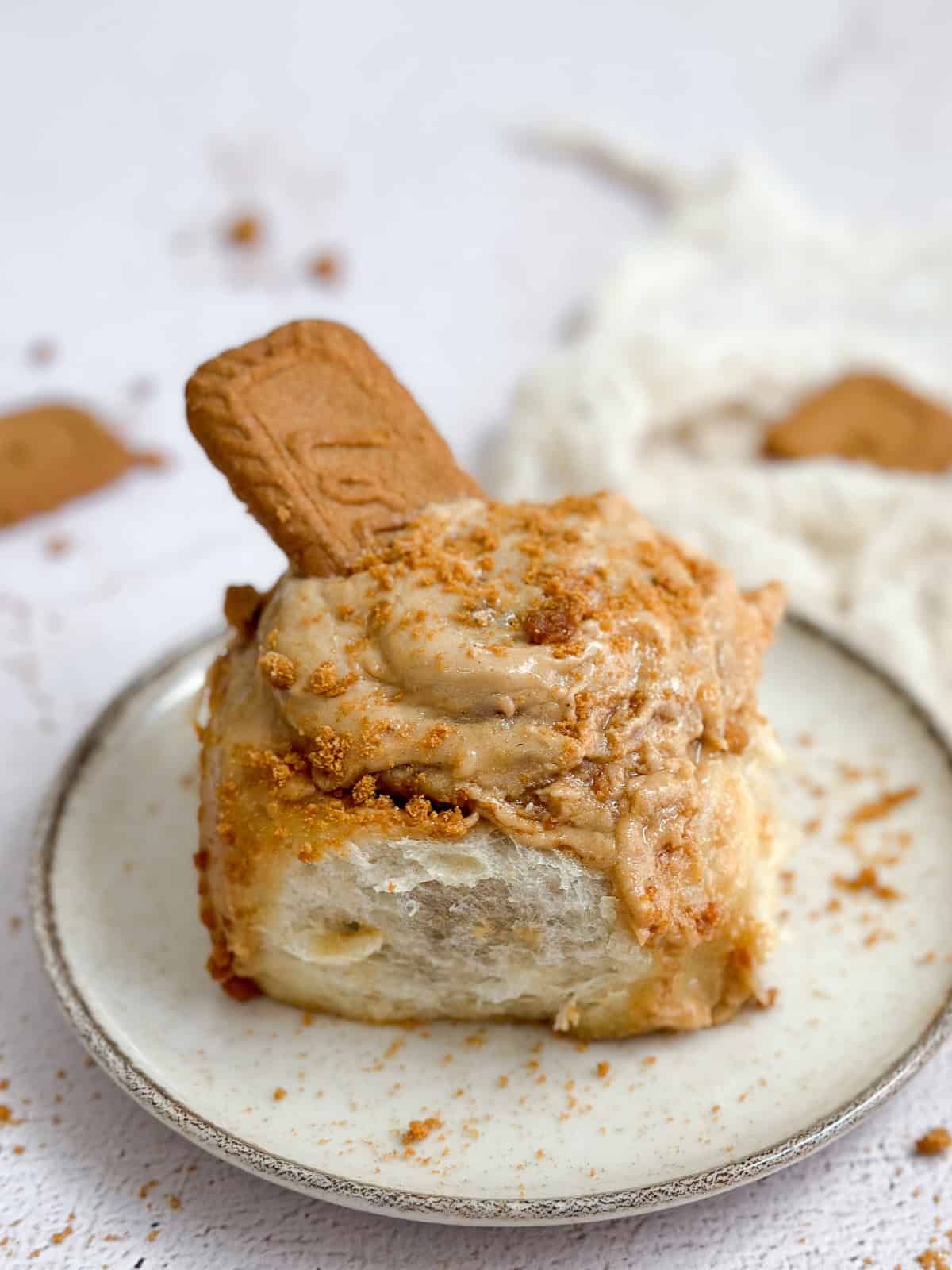 a biscoff cinnamon roll with a cookie coming put the top.