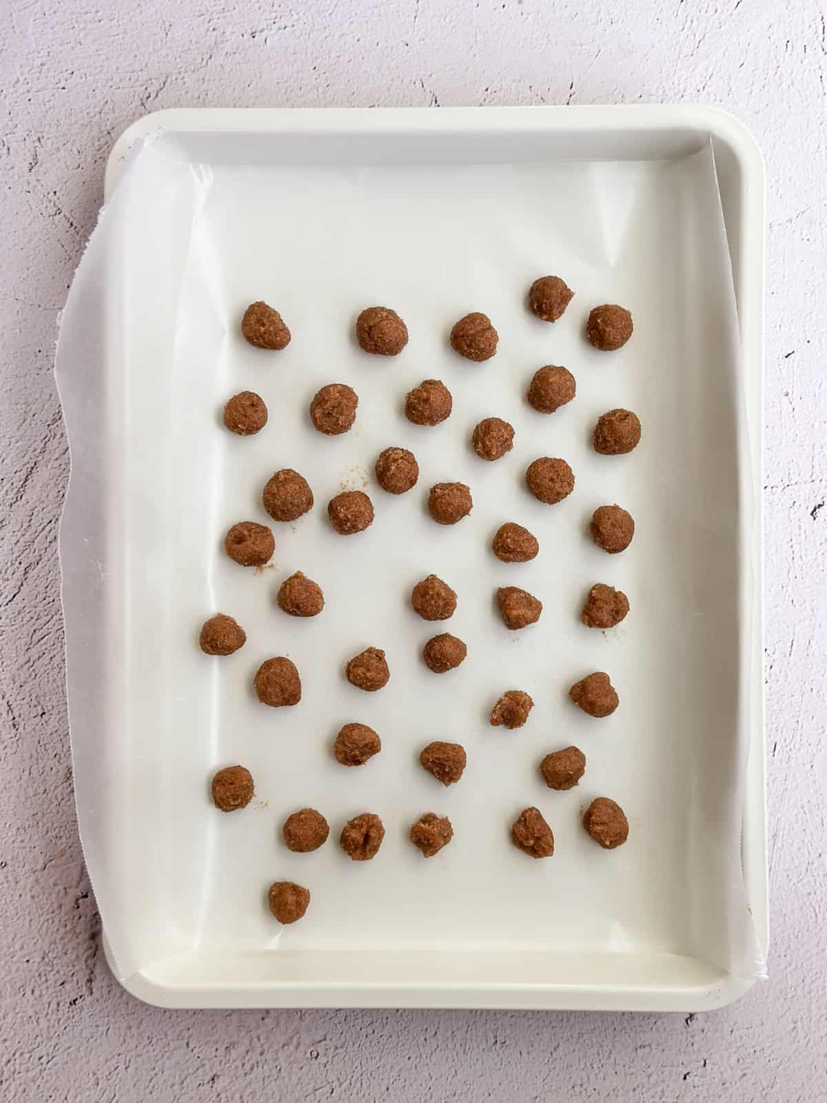 cinnamon roll bits on wax paper, showing the size of balls.