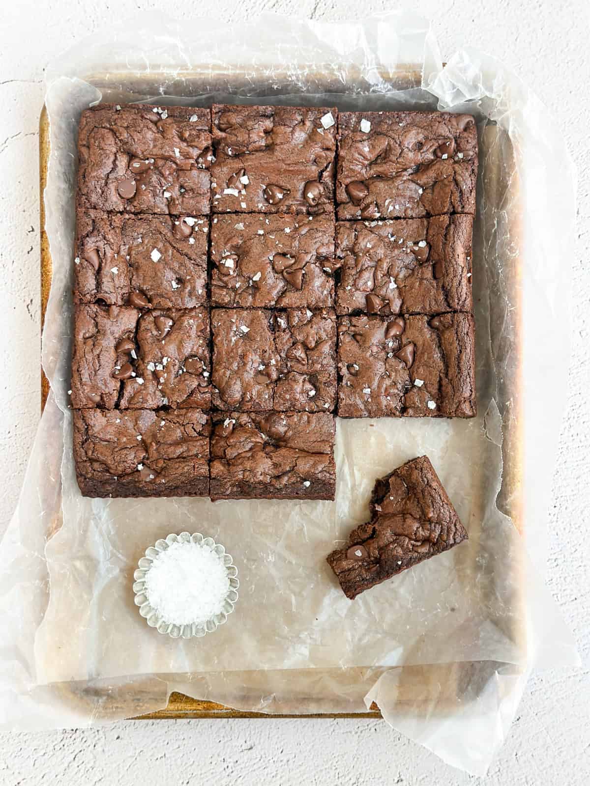 all the double chocolate cookie bars cut and placed on a large baking sheet with extra salt.