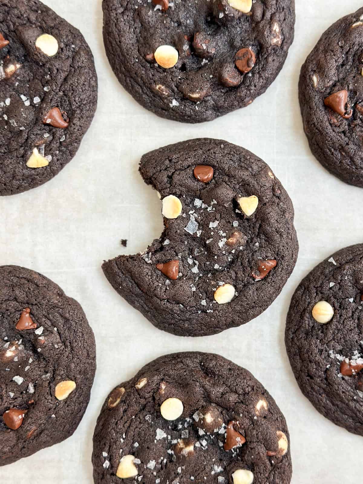 a bite missing from an inside out chocolate chip cookie.