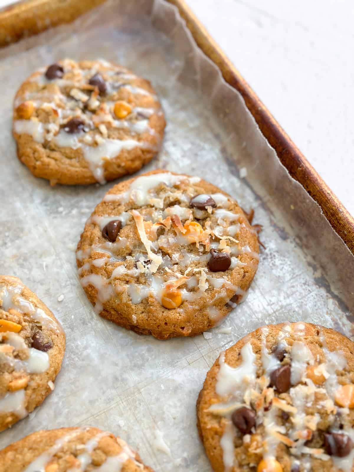 a few hello dolly cookies on the baking sheet.