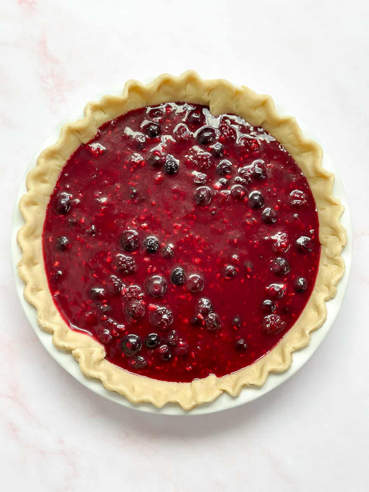 pie filling into the pie dough.