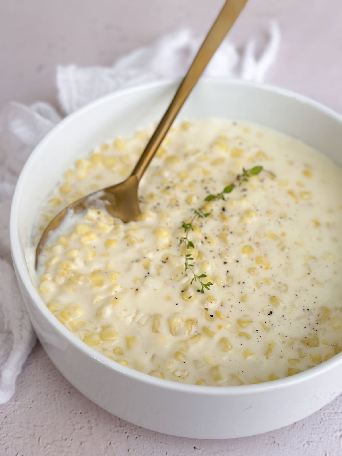 the whole bowl of easy creamed corn with a serving spoon.